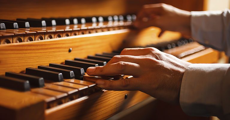 _0000_Organ in a Church Closeup of a man playing a church organ