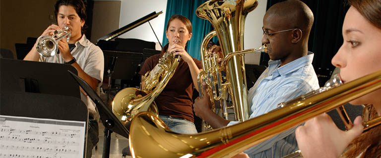 Team & Culture students playing brass instruments in a group